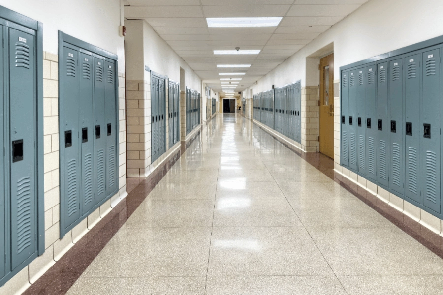row of blue lockers in school highway with bright lighting